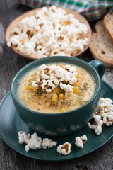corn soup with popcorn in cup,vertical