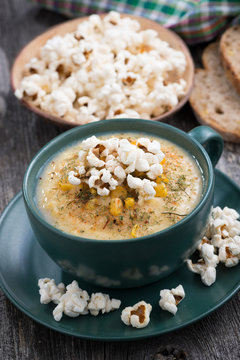 corn soup with popcorn in cup,vertical