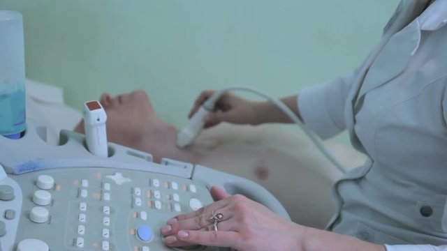 Doctor using the ECHO ultrasonography examines human thyroid gland close up 3