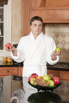 man in the kitchen holding fruits