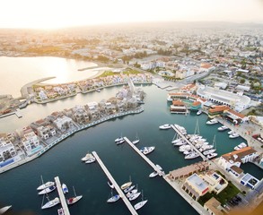 Aerial view of the beautiful Marina in Limassol city in Cyprus,beach,boats,piers,villas and commercial area.A modern,high end,newly developed space with docked yachts and for a waterfront promenade.