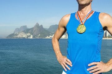 Gold medal gay athlete standing on Ipanema Beach in Rio de Janeiro, Brazil 