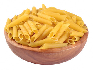 Italian pasta penne in a wooden bowl on a white