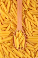 Italian pasta penne in a spoon