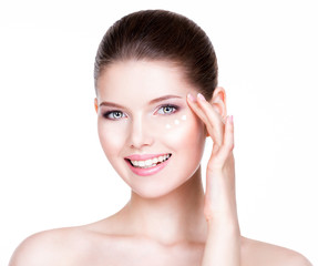 Obraz na płótnie Canvas Woman with healthy face applying cosmetic cream.