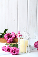 Beautiful pink roses on a white wooden table