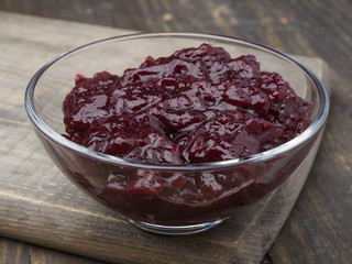 jam bowl with ripe blueberries on wooden