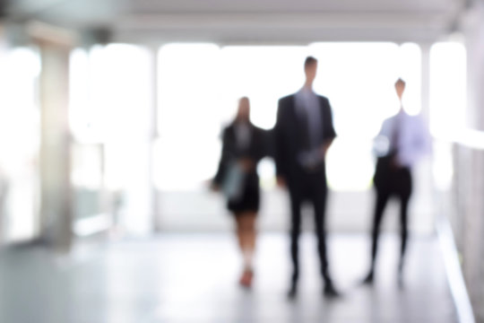 Blurred business people standing in building hall