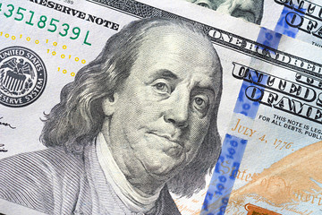 Close up of Benjamin Franklin face on 100 US dollar bill