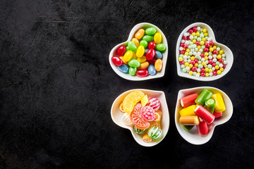 Four ceramic heart shaped bowls with candies