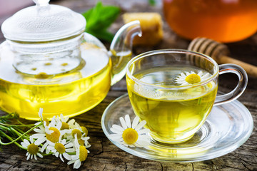 Chamomile tea on wooden background