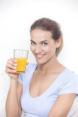 Young beautiful smiling woman with glass of orange juice