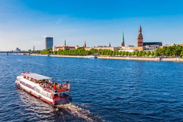 Walking ship floats the river Daugava, panoramic view of Riga, Latvia