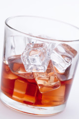 glass of whiskey with ice cubes