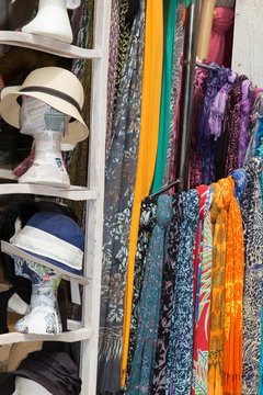 Colorful scarfs and hat on a market stall