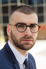 Portrait of young caucasian businessman in the city