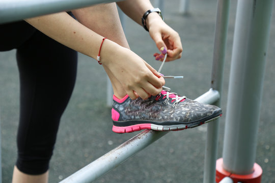 Sporty woman tie shoe laces, close up view