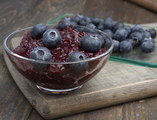 bowl with jam and blueberries, on wood