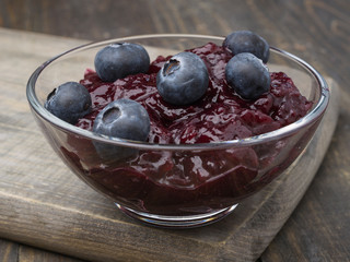 bowl with jam and blueberries, on wood