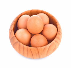 egg in a wooden bowl isolated on white background