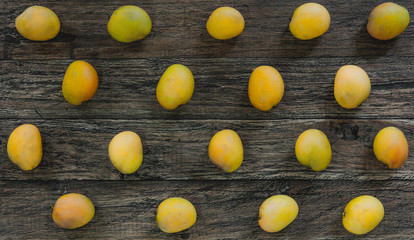 Yellow mangoes on wooden table