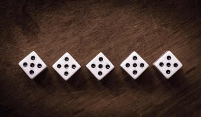 Number five dice on wooden table