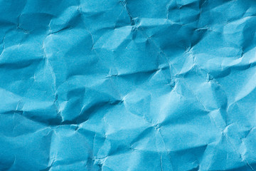 Textured background of wrinkled blue paper