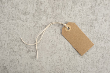 Blank paper tag on stone background. Concept of sale, shipping or retail pricing. - 112203730