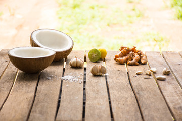 Raw material for food and dessert.Lemon and coconut and turmeric on old wooden background outdoor.Raw material Asia food.Raw material Indian food