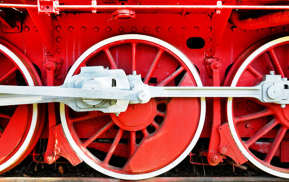 Detail of the wheels of a steam locomotive. Red wheels of an old steam locomotive