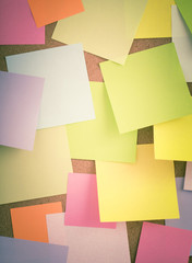 Empty blank sticky notes on notice board in office. Background or backdrop for business information. Concept image of communication or reminder with copy space.