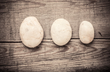 Stones on wooden background, concept of harmony and tranquility. Decoration with stone pebbles as natural design backdrop with copy space.