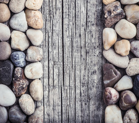 Stones on wooden background, concept of harmony and tranquility. Decoration with stone pebbles as natural design backdrop with copy space.