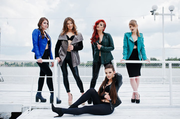Fototapeta premium Group of sexy models girls in black bra and leather jackets on t