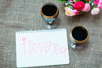 two glasses of red wine and flowers