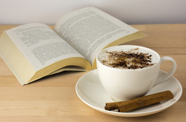 Coffee cup on table and cinnamon