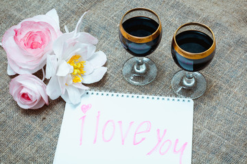 two glasses of red wine and flowers