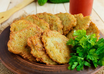 Village vegetarian pancakes made from potatoes in a clay bowl. 