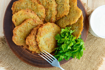 Village vegetarian pancakes made from potatoes in a clay bowl. 