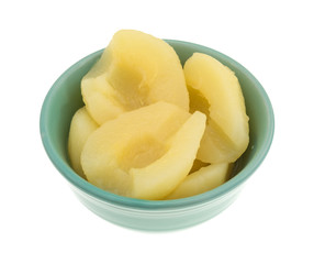 Side view of a bowl of pears halves isolated on a white background