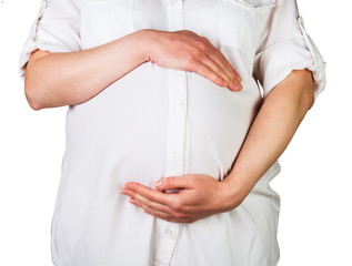 Pregnant woman tenderly embracing  the stomach isolated on white.