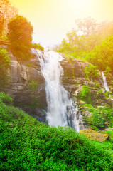 Fototapeta na wymiar Beautiful waterfall with sunlight in autumn forest, Thailand