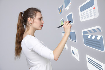 Woman pressing multimedia and entertainment icons on a virtual background