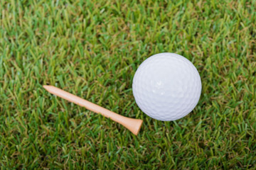 White Golf ball on green grass