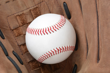 baseball in the pocket of a glove sports concept
