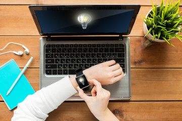 close up of woman with smart watch and laptop