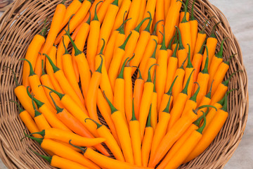 Close up orange or yellow chili in ratten basket