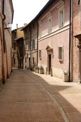 Fototapeta na wymiar Lane in Urbino, with small street and little buildings of red bricks, Italy