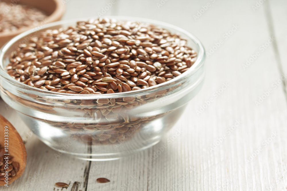 Wall mural flax seeds in bowl on table