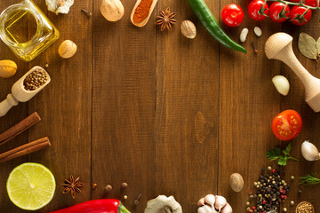 herbs and spices on wood background